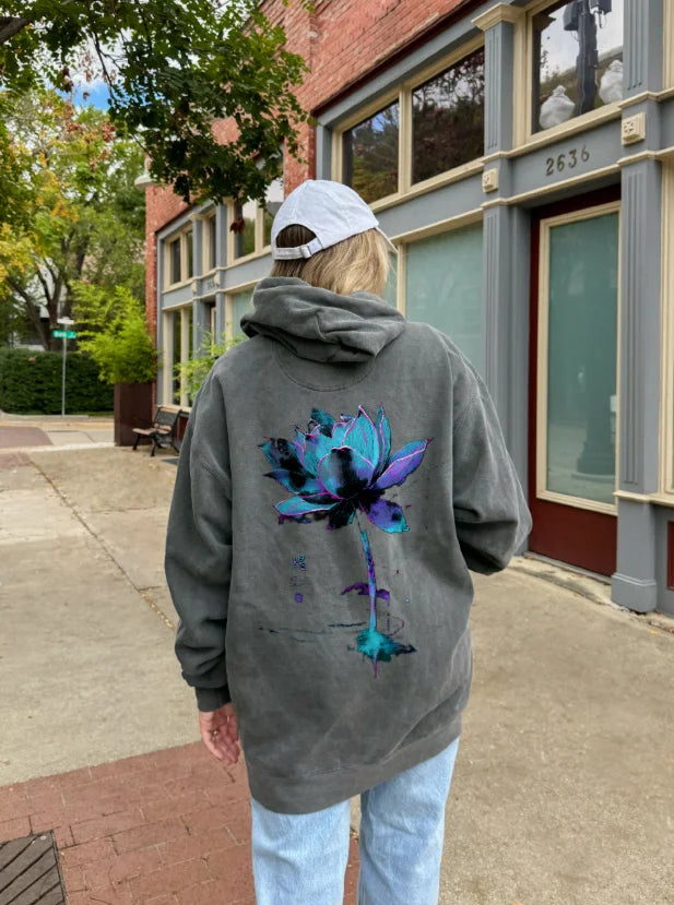 Lifestyle shot wearing premium Japanese art hoodie with lotus flower sumi-e design.
