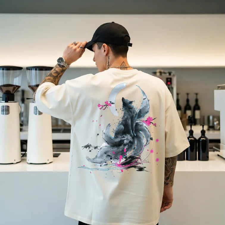 Digital sumi-e ink artwork of a nine-tailed fox beneath a crescent moon with neon blossoms, printed on the back of a white unisex Comfort Colors oversized t-shirt.
