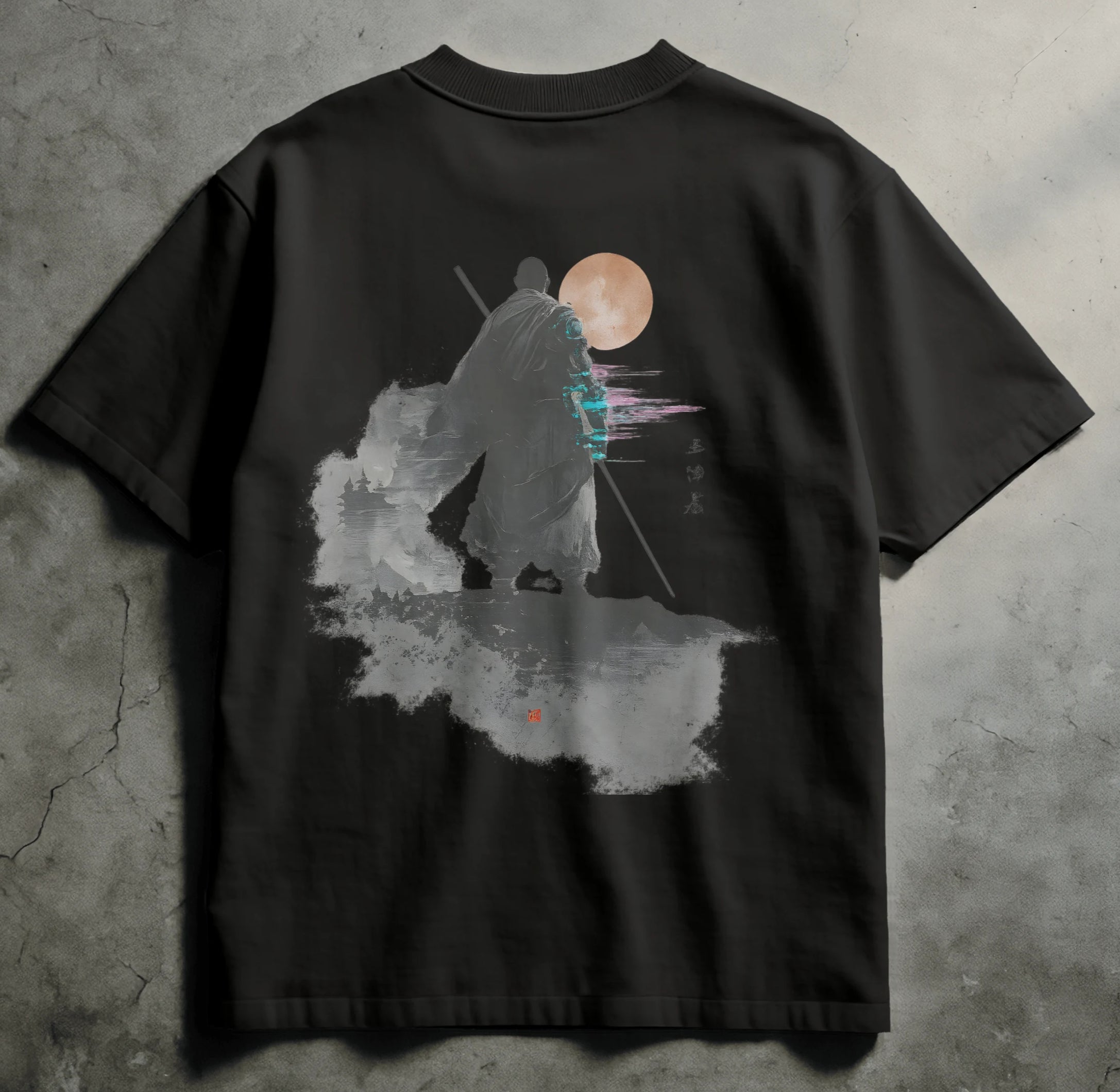 Black t-shirt with a graphic design of a bear and moon on a concrete surface