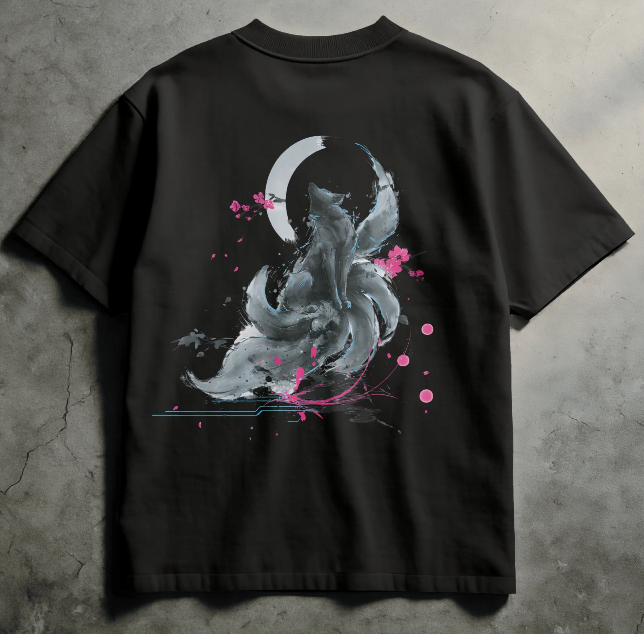 Black t-shirt featuring a sumi-e inspired design of a fox spirit with multiple swirling tails, sitting beneath a crescent moon. Neon pink blossoms and glitch-like accents surround the fox, blending traditional Japanese brushwork with cyberpunk elements.