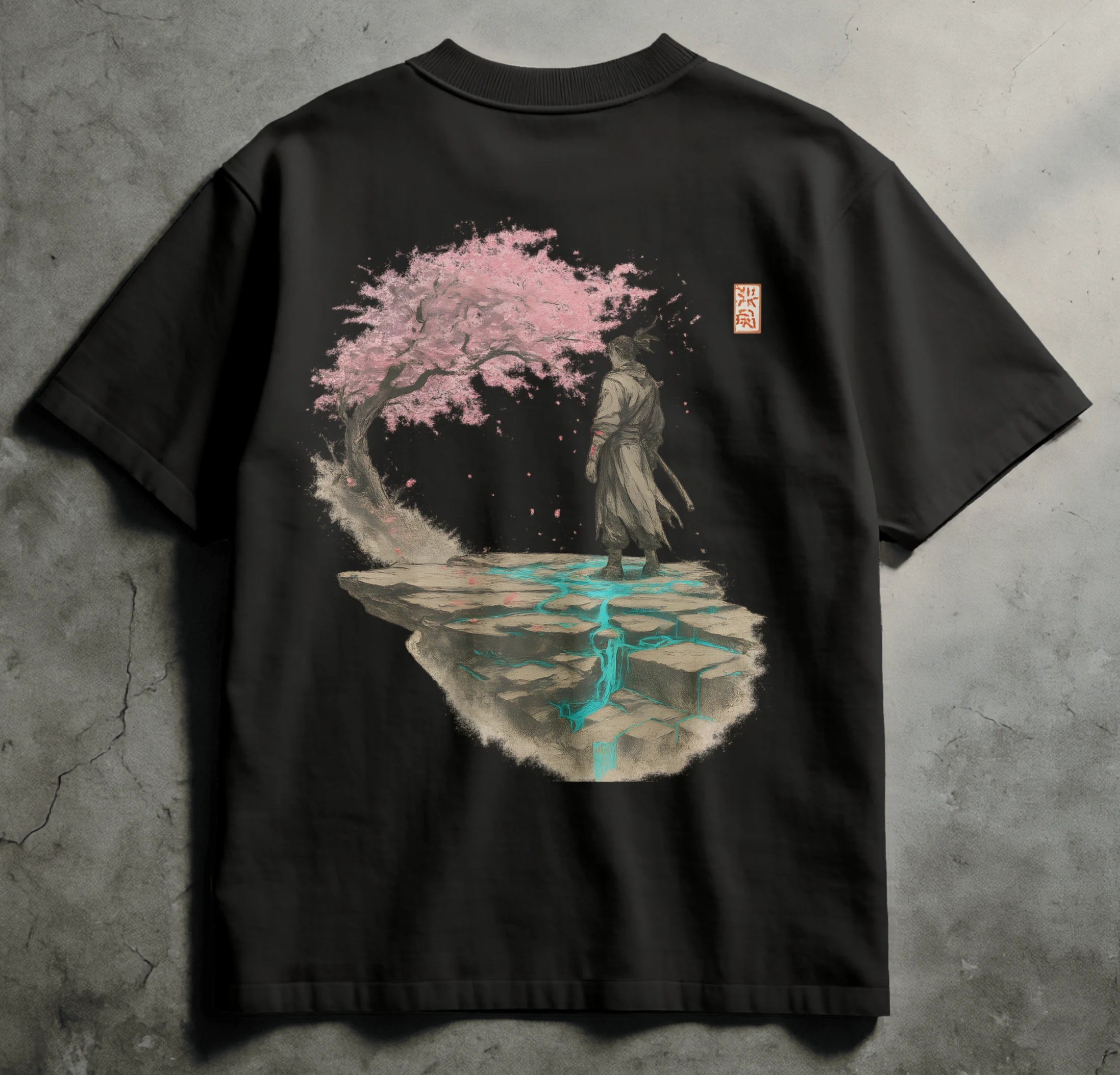 Black t-shirt with a cherry blossom design on a gray concrete background